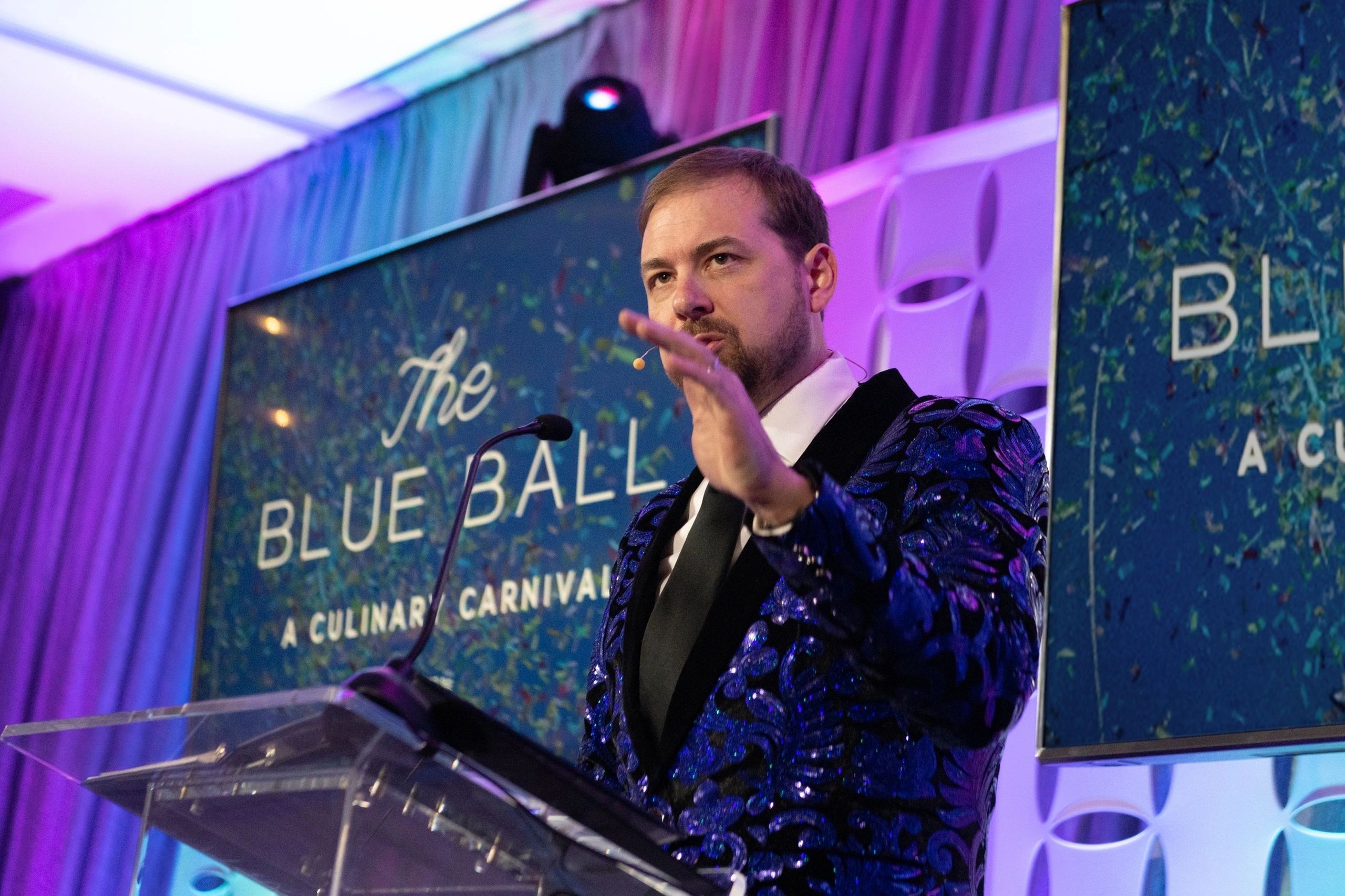 Jonathan R. Larsen auctioneering at The Blue Ball — A Culinary Carnival